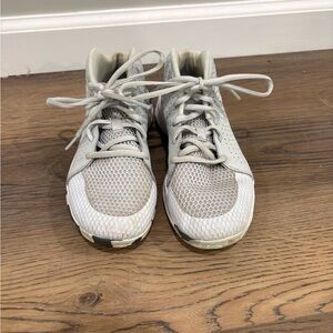 Under Armour Cream and Gray basketball shoes.